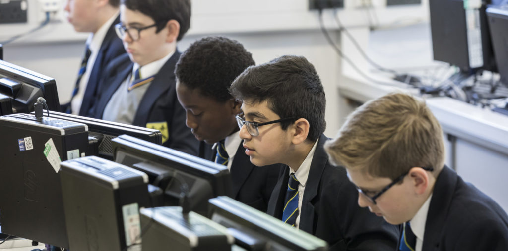 A group of boys working on computers in the IT suite.