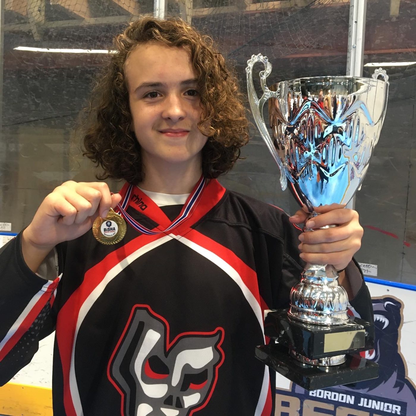 Photo of Daniel Alabaster from Year 10, holding up his U19 Roller Hockey National Finals medal and trophy for the camera.