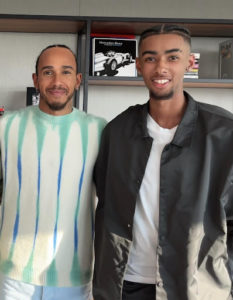 A former SJWMS student, Ruben, is seen posing for a photo with Lewis Hamilton.