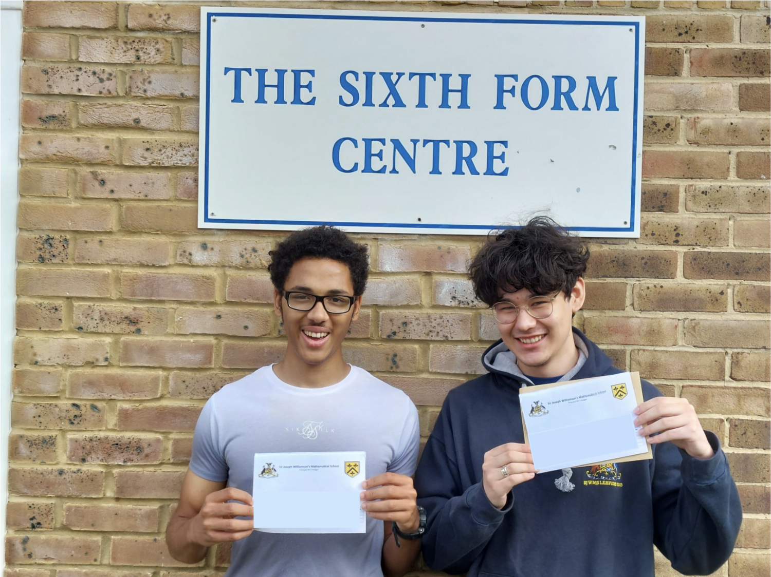 Abayomi and Jian holding their results