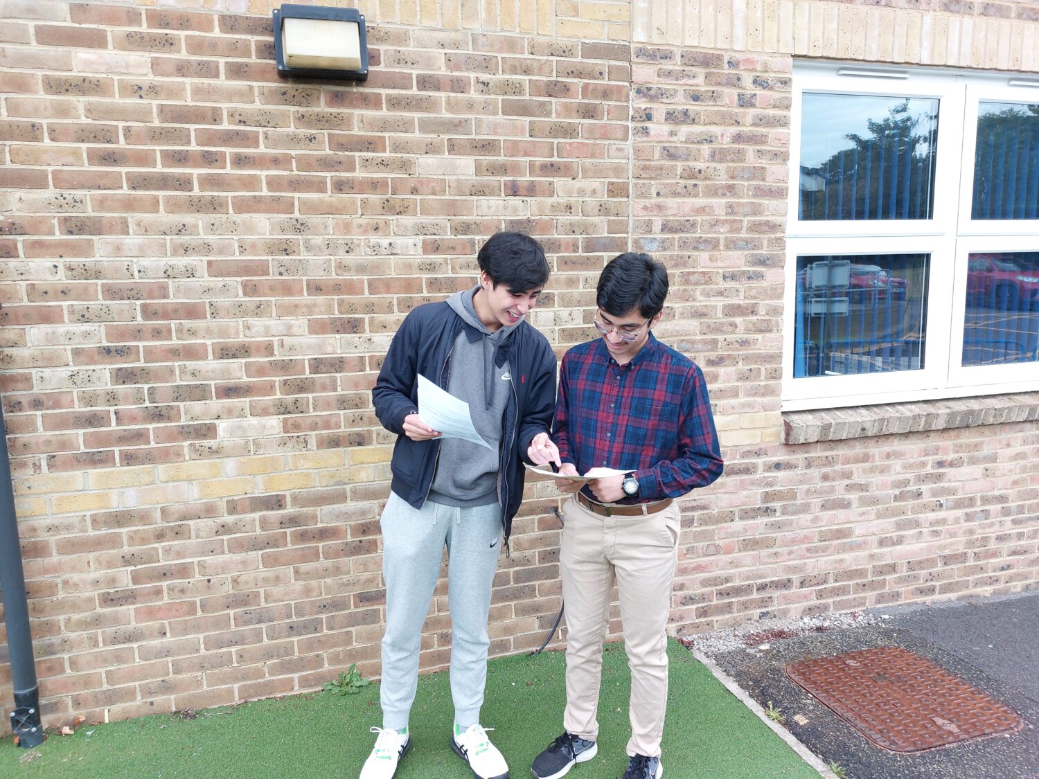 Liam and Muhammad collecting their results