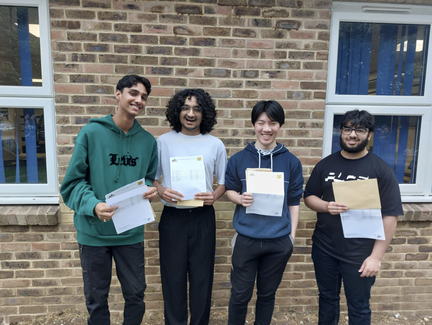 Anish, Hashim, Matthew and Adam holding their results