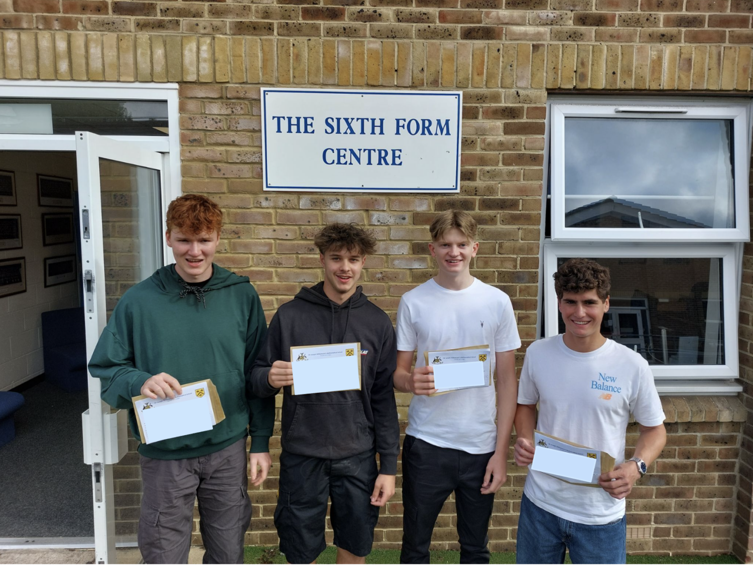 Tom, Tom, Bailey and Oliver holding their results