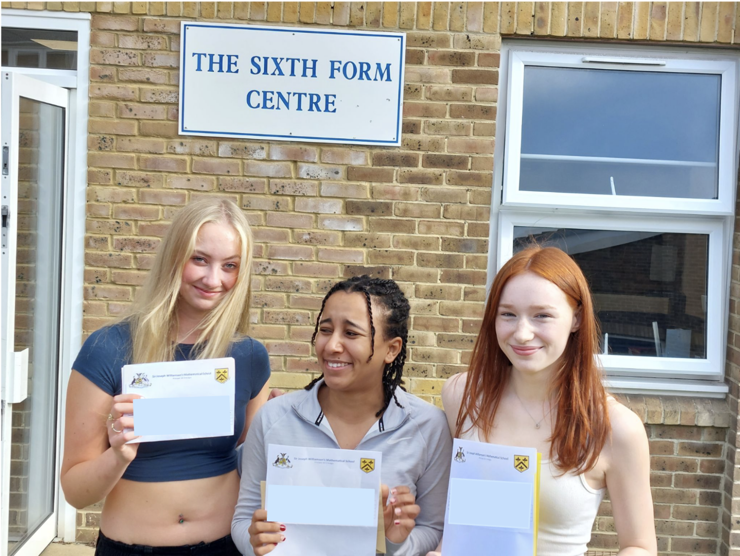 Zara, Sarah and Jess holding their results
